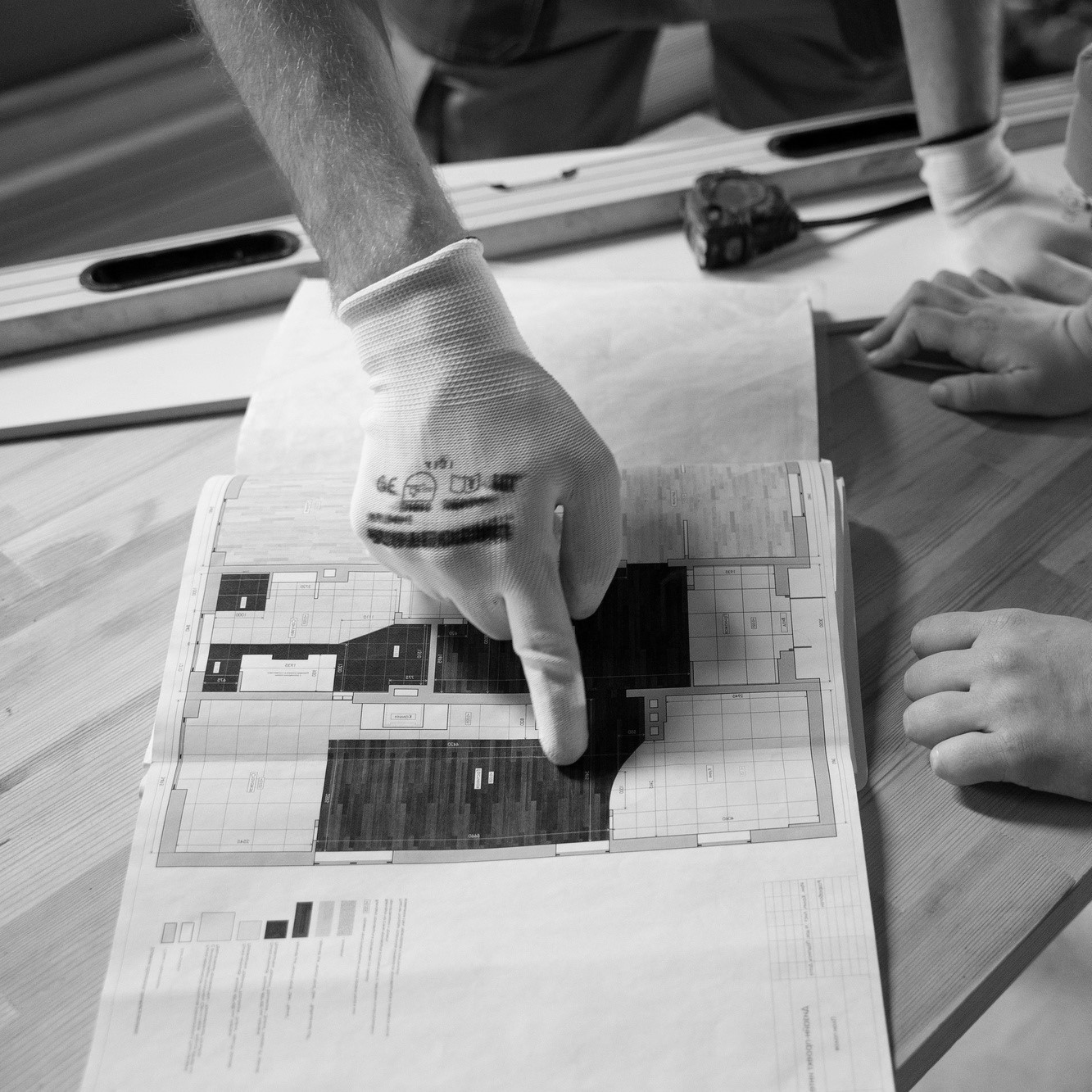 man pointing at a floor plan